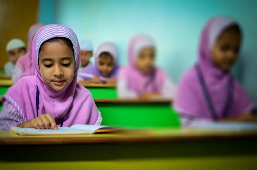 pexels-photo-448877-448877 Group of young students in traditional hijabs focusing on their studies in a classroom.